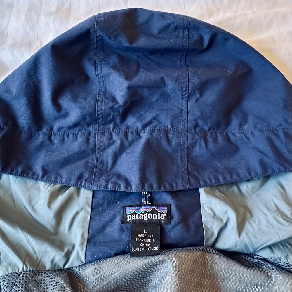 Patagonia Blue Raincoat with hood.
